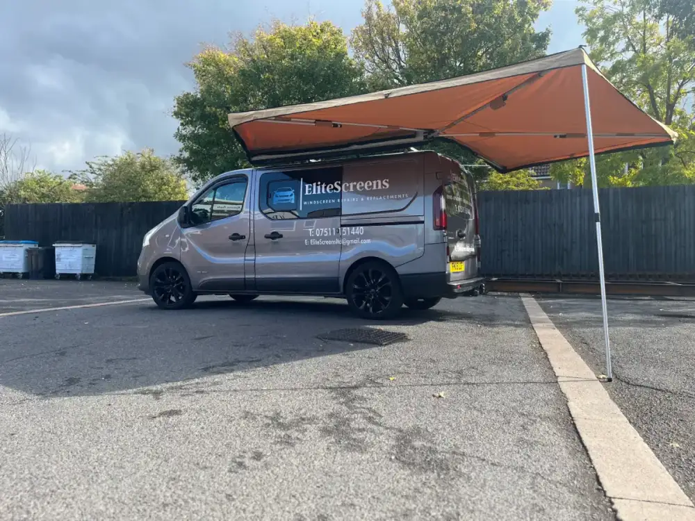 The EliteScreens van parked on-site with its awning up